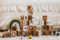 Children's wooden alphabet blocks on carpet with marbles 